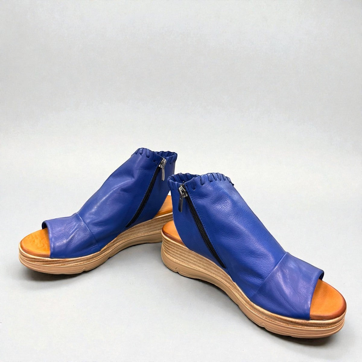 Roamers Eden sax blue leather wedge sandal with side zipper and decorative whipstitch detailing.
photo of the front side