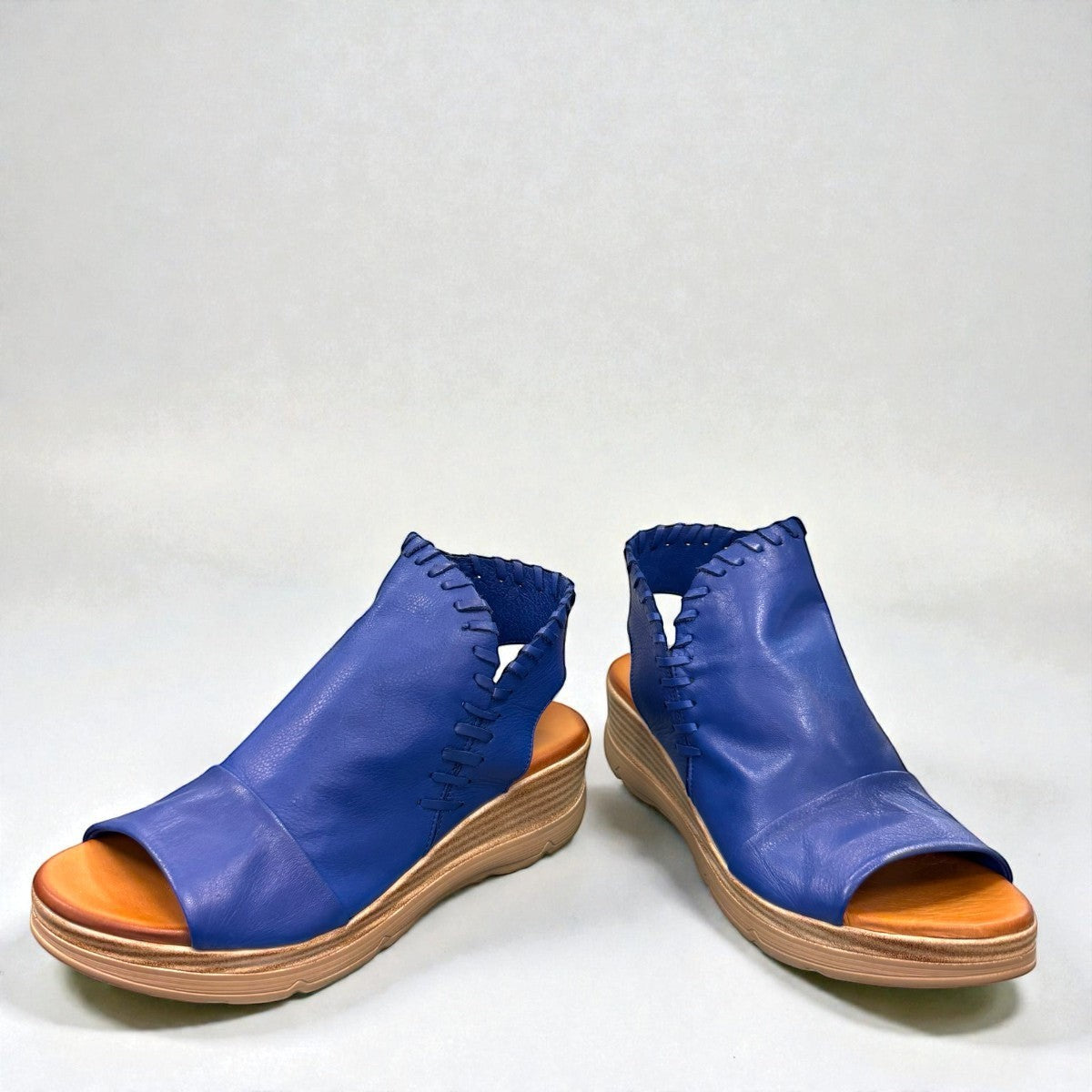 Roamers Eden sax blue leather wedge sandal with side zipper and decorative whipstitch detailing.
photo of the front side