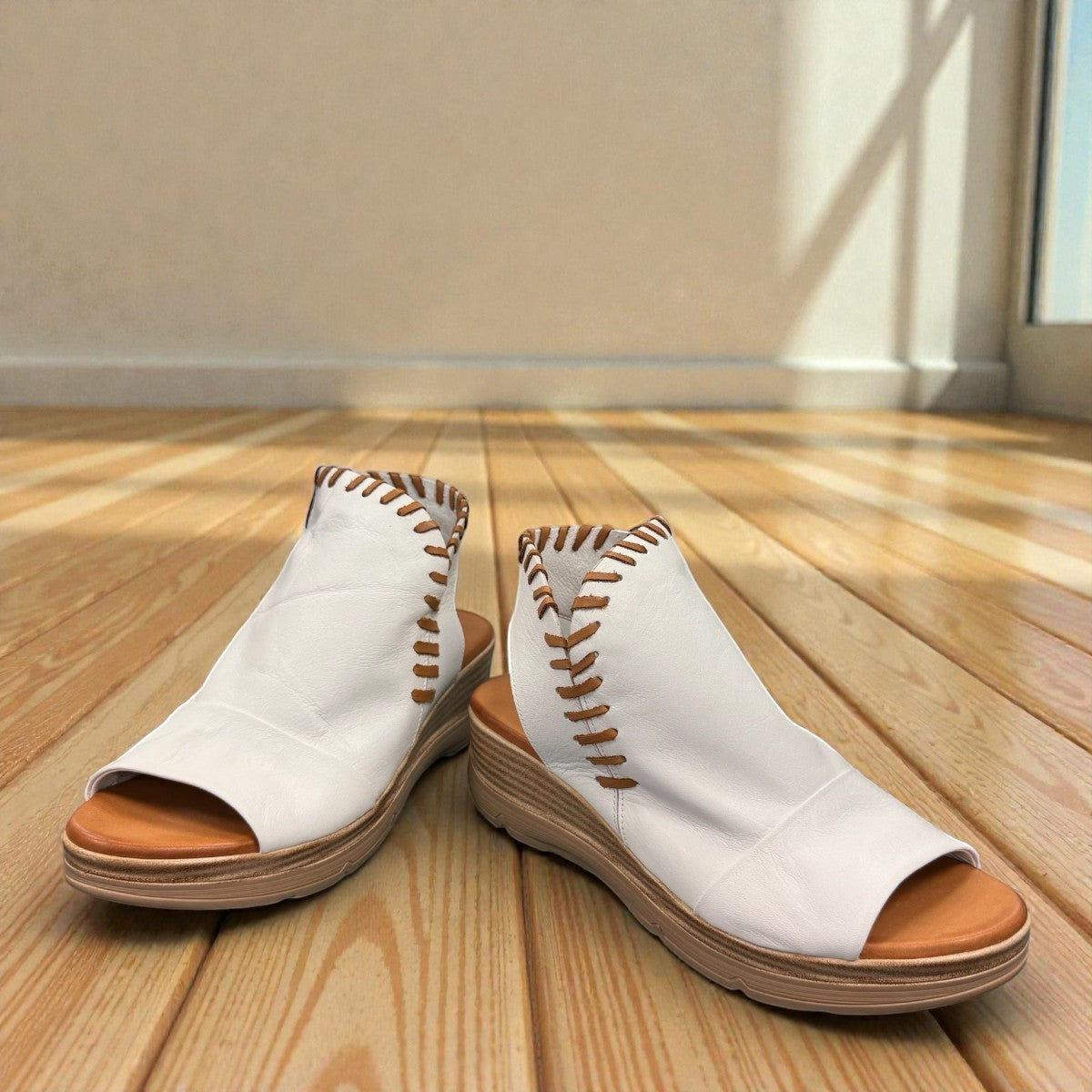 Roamers Eden white leather wedge sandal with brown lace-up detail and side zipper entry.
photo of the front side