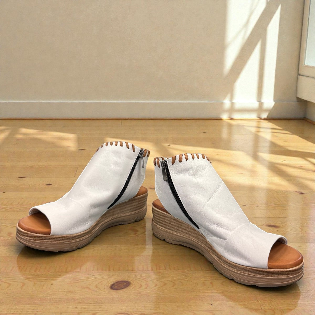 Roamers Eden white leather wedge sandal with brown lace-up detail and side zipper entry.
photo of the front side