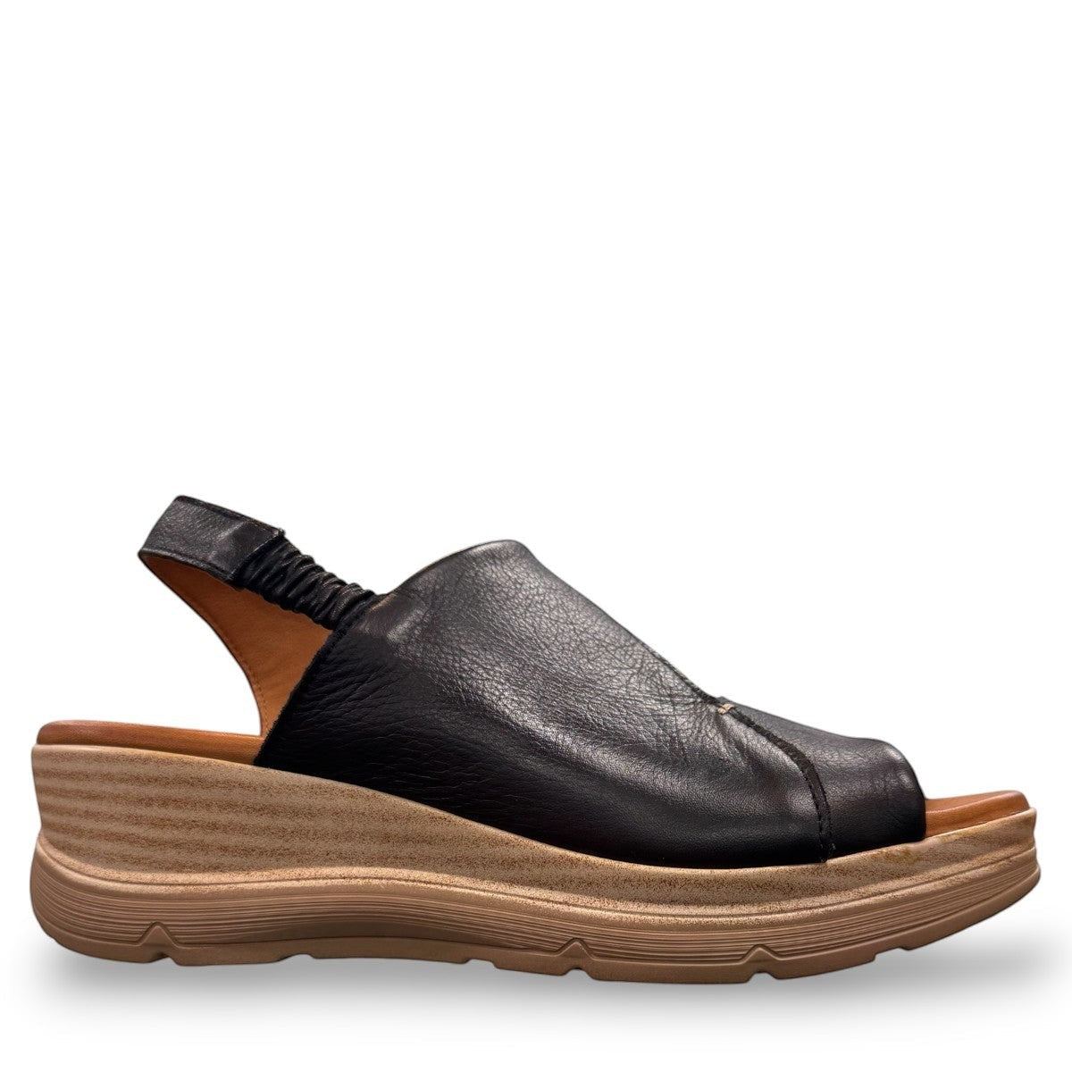 Roamers Ellsie black leather sling-back wedge sandal with elastic strap and textured platform sole.
photo of the right side