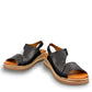 Roamers Ellsie black leather sling-back wedge sandal with elastic strap and textured platform sole.
photo of the front side