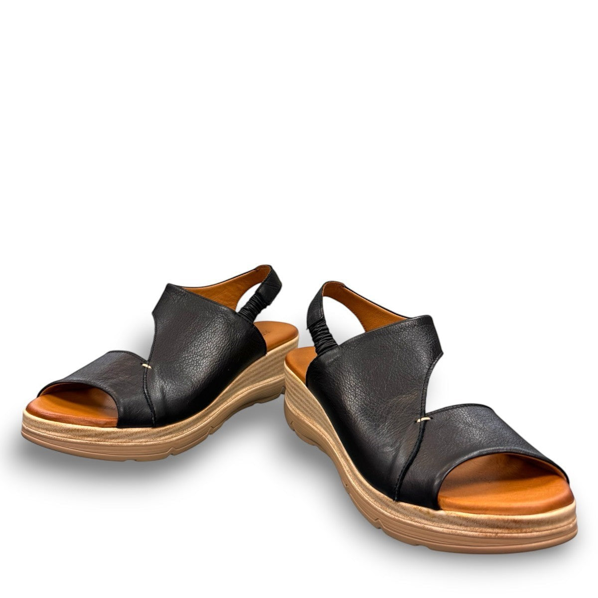 Roamers Ellsie black leather sling-back wedge sandal with elastic strap and textured platform sole.
photo of the front side