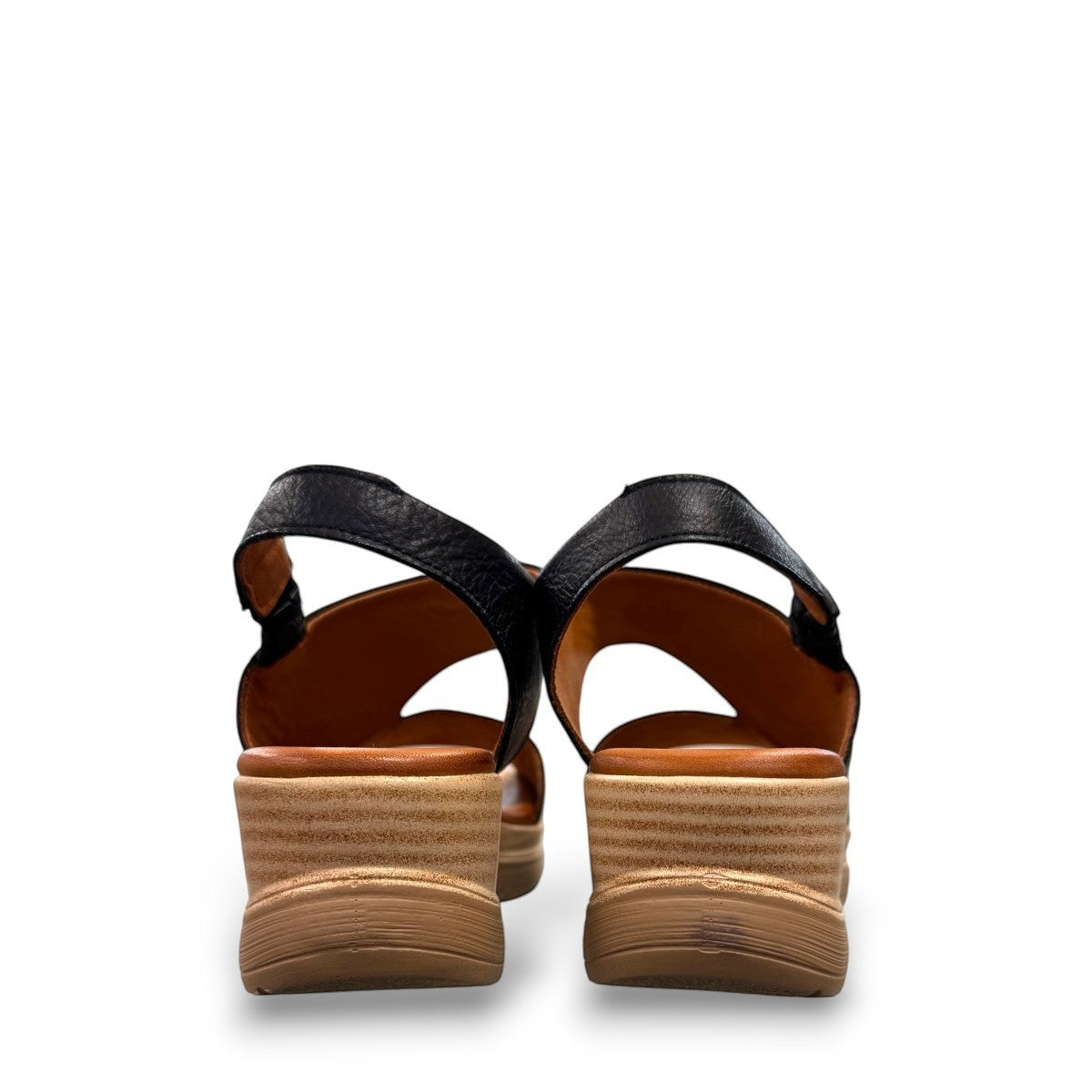 Roamers Ellsie black leather sling-back wedge sandal with elastic strap and textured platform sole.
photo of the back side