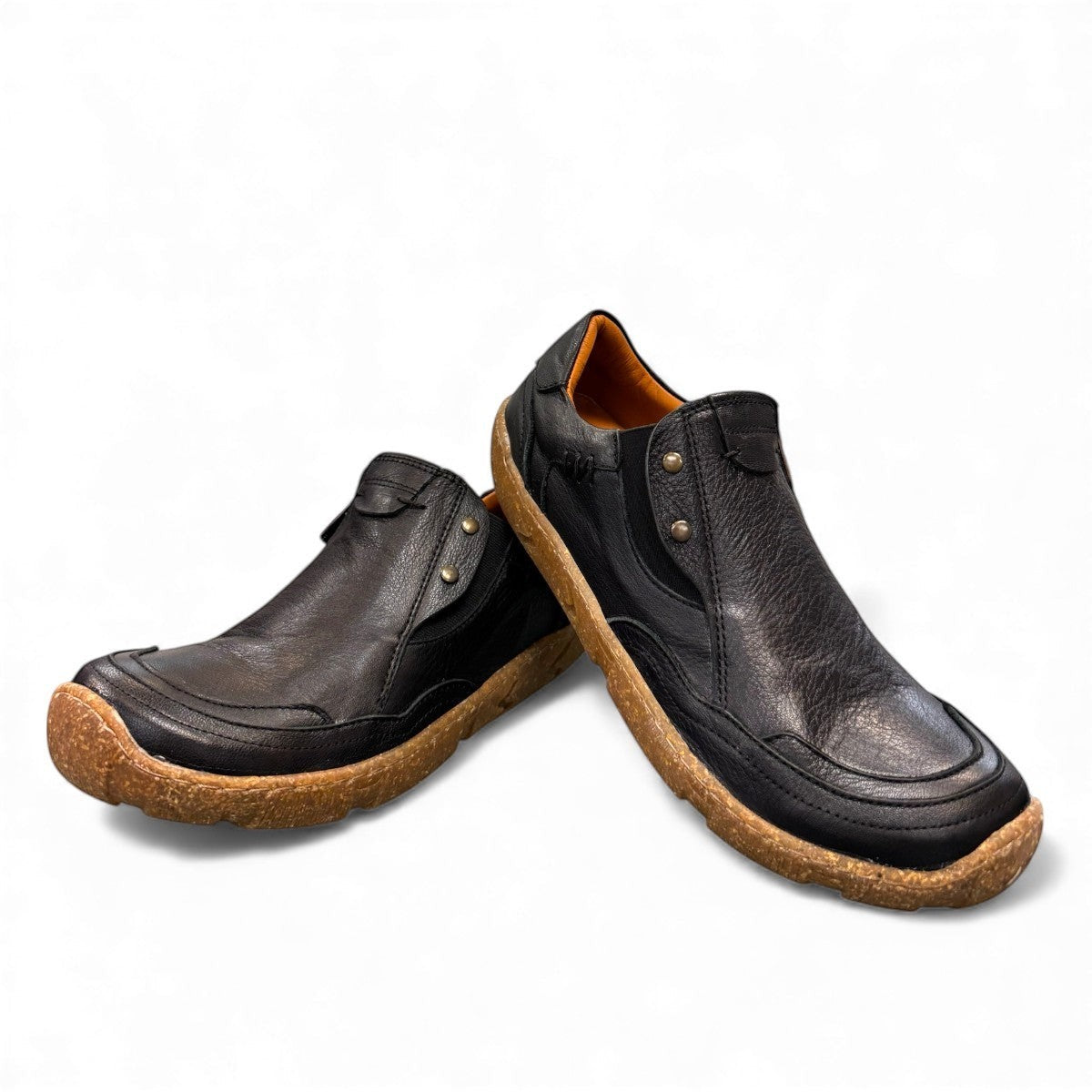 Roamers Enid black leather slip-on shoe with contrast stitching and a textured brown rubber sole.
photo of the front side