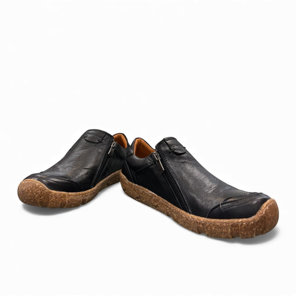Roamers Enid black leather slip-on shoe with contrast stitching and a textured brown rubber sole.
photo of the front side