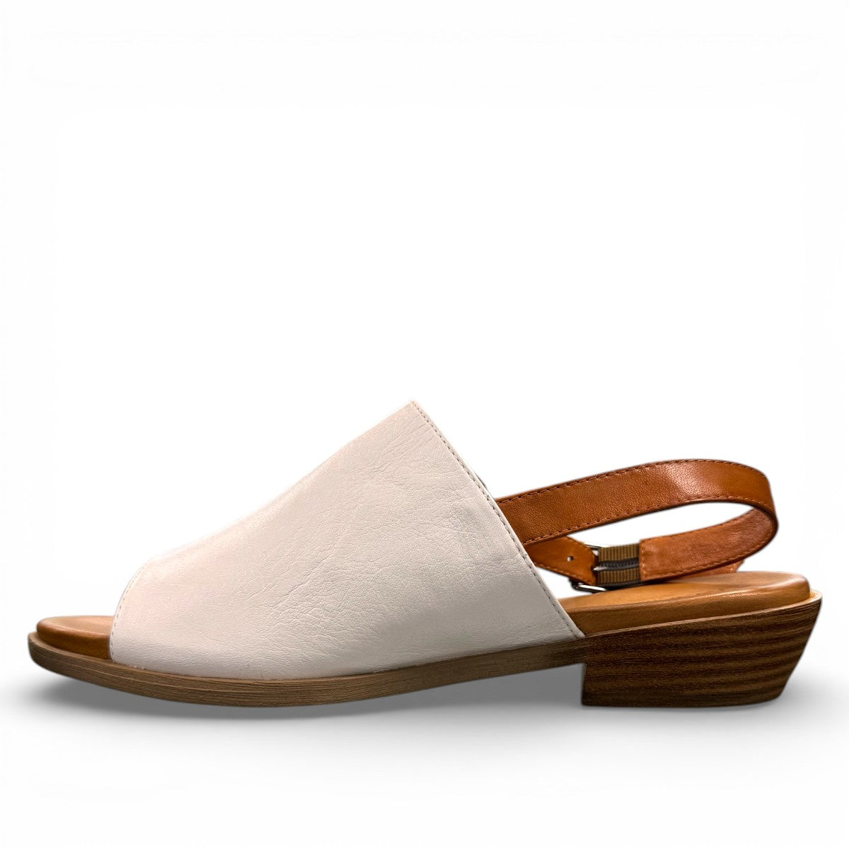 roamers Jude low heel sandal in white coconut leather with a brown side buckle strap and stacked heel.
photo of the left side
