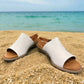 roamers Jude low heel sandal in white coconut leather with a brown side buckle strap and stacked heel.
photo of the front side