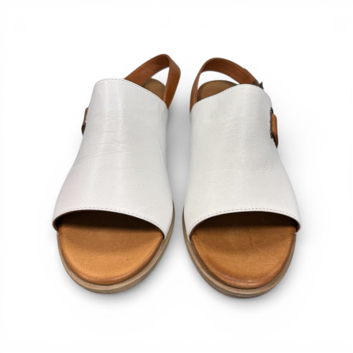 roamers Jude low heel sandal in white coconut leather with a brown side buckle strap and stacked heel.
photo of the top side