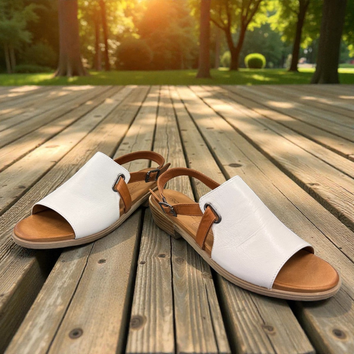 roamers Jude low heel sandal in white coconut leather with a brown side buckle strap and stacked heel.
photo of the front side