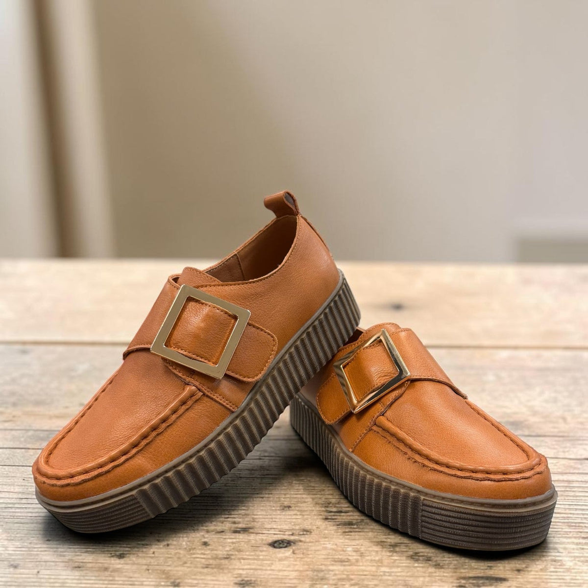 Roamers Khloe tan leather loafer with a gold buckle and thick ribbed platform sole, side view.