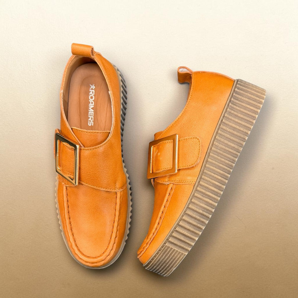 Roamers Khloe tan leather loafer with a gold buckle and thick ribbed platform sole, side view.
