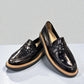 ROAMERS NILA black metallic leather loafer with a platform sole and saddle strap detail.
photo of the front side