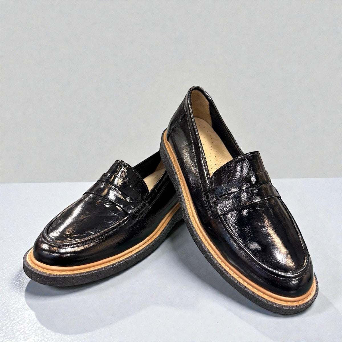 ROAMERS NILA black metallic leather loafer with a platform sole and saddle strap detail.
photo of the front side