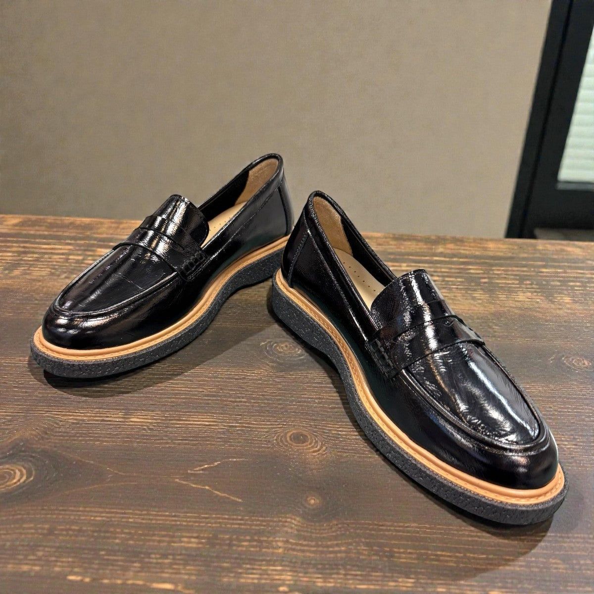 ROAMERS NILA black metallic leather loafer with a platform sole and saddle strap detail.
photo of the front side