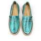 Roamers Nila metallic teal leather loafer with a brown platform sole and moccasin-style stitching.
photo of the top side