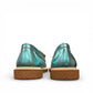 Roamers Nila metallic teal leather loafer with a brown platform sole and moccasin-style stitching.
photo of the back side