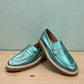 Roamers Nila metallic teal leather loafer with a brown platform sole and moccasin-style stitching.
photo of the front side