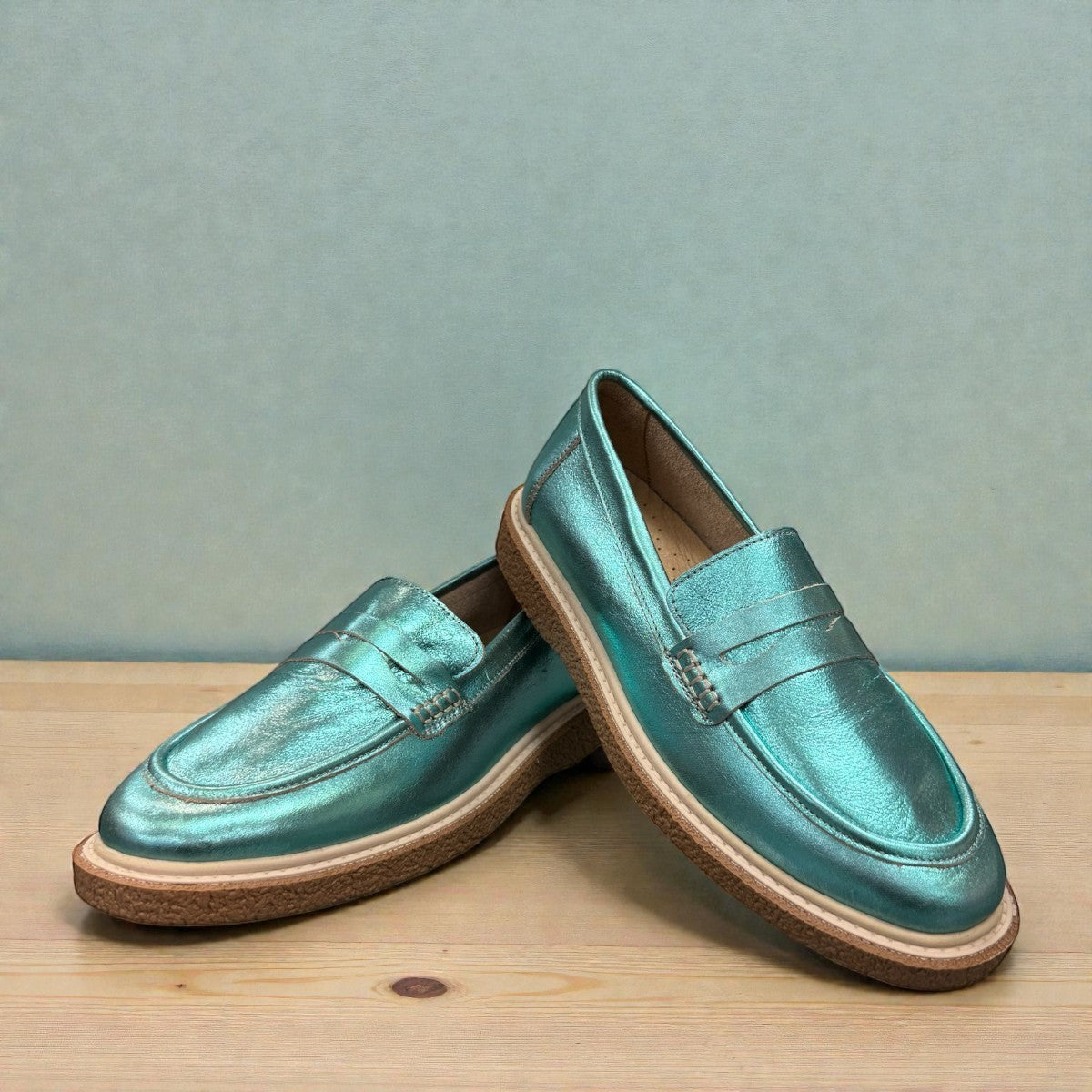 Roamers Nila metallic teal leather loafer with a brown platform sole and moccasin-style stitching.
photo of the front side