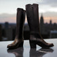 Roamers Peace black leather knee-high boot with block heel and decorative side zipper.
photo of the front side