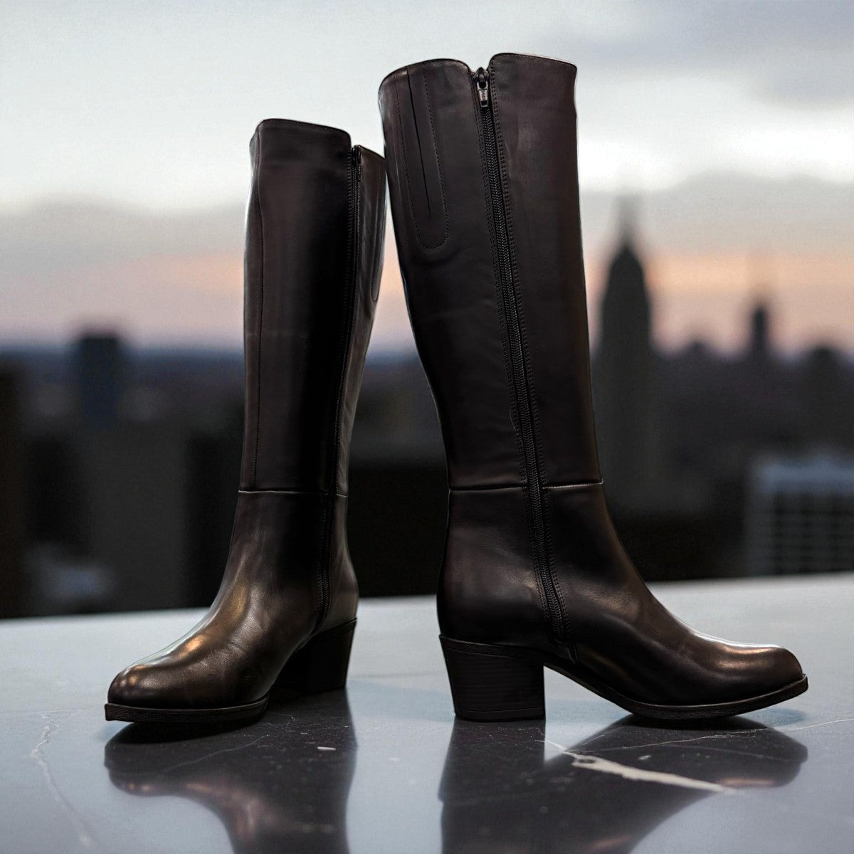 Roamers Peace black leather knee-high boot with block heel and decorative side zipper.
photo of the front side