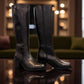 Roamers Peace black leather knee-high boot with block heel and decorative side zipper.
photo of the side