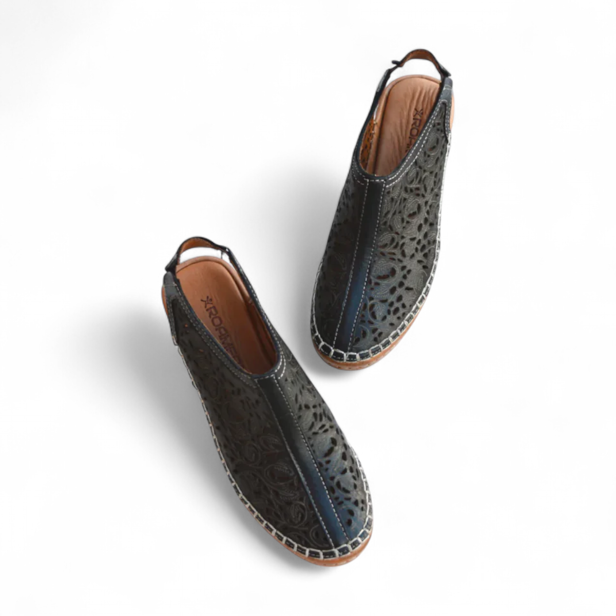 Roamers Petra black leather wedge sandal with laser-cut floral detailing and back strap  elastic gore.
photo of the top side