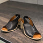 Qiana black leather open-toe sandals with a 3-inch block heel and elasticated back strap.
photo of the front side