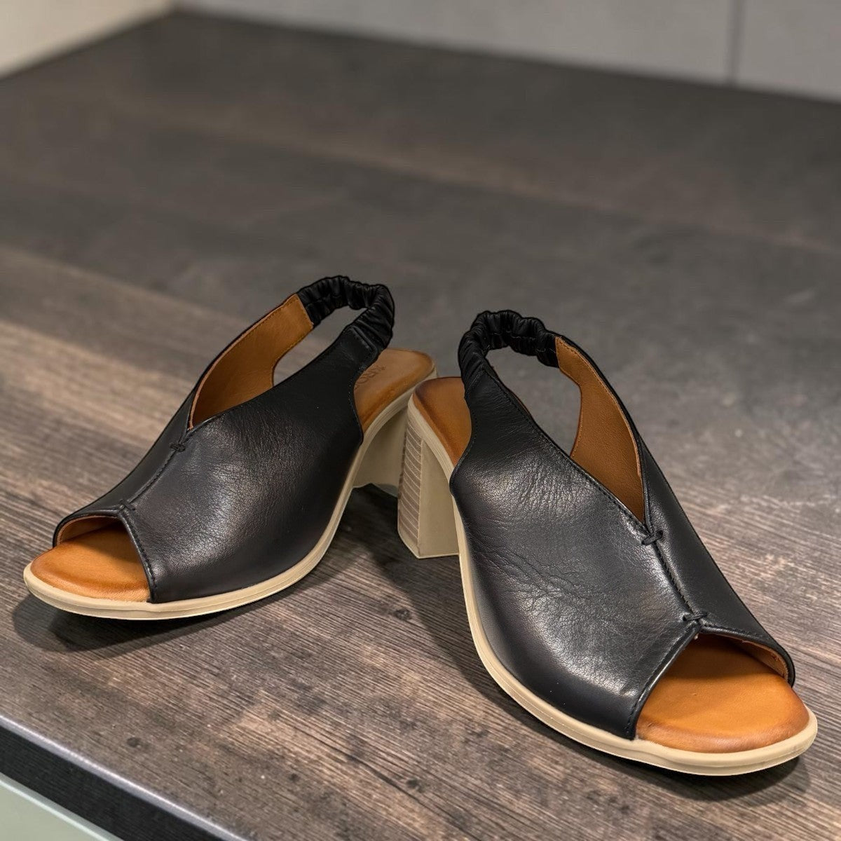 Qiana black leather open-toe sandals with a 3-inch block heel and elasticated back strap.
photo of the front side