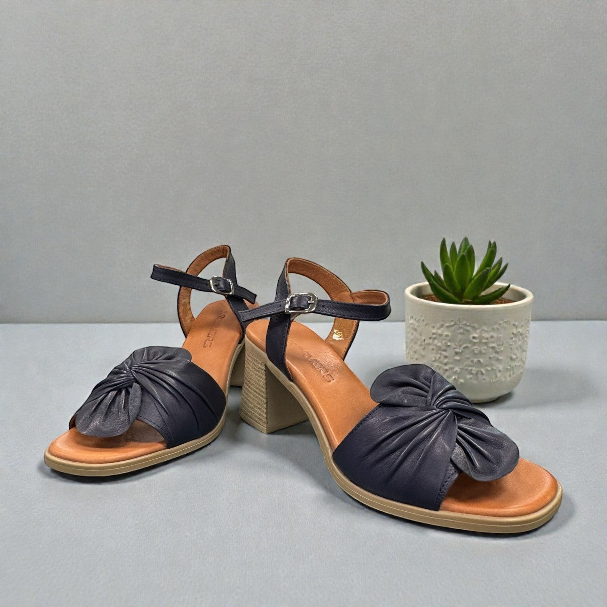 Roamers Quana navy leather heeled sandals with an adjustable instep strap and 2.5-inch block heel.
photo of thefront side