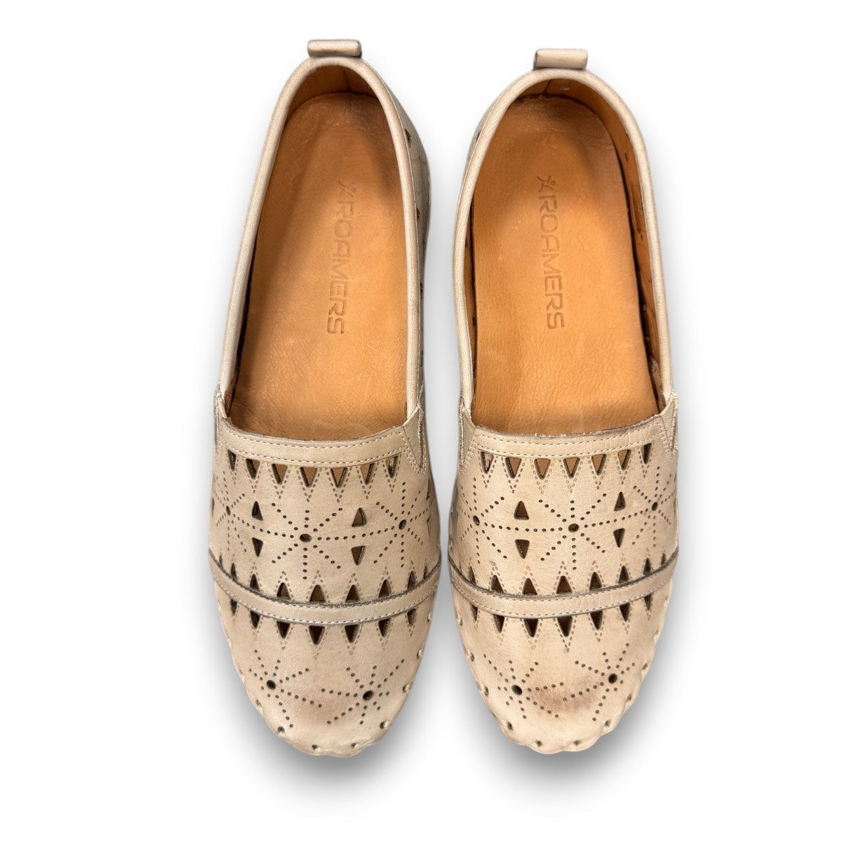 roamers silver gray leather slip-on loafer with geometric laser cutouts and artisan stitched detailing.
photo of the top side