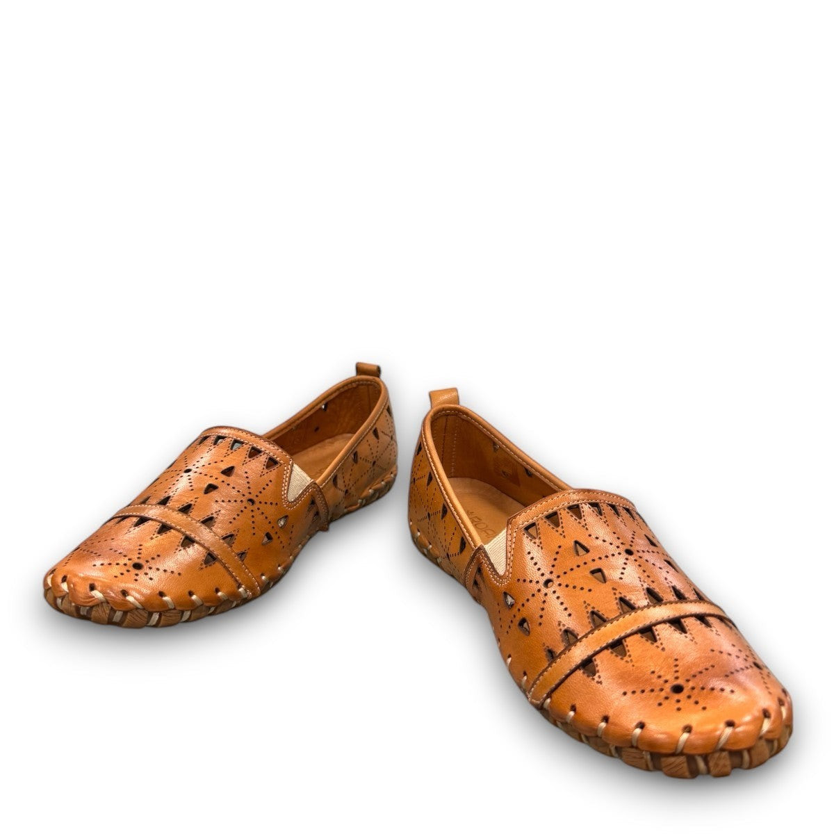roamers tan leather slip-on loafer with geometric laser cutouts, artisan stitching, and flexible rubber outsole.
photo of the front side