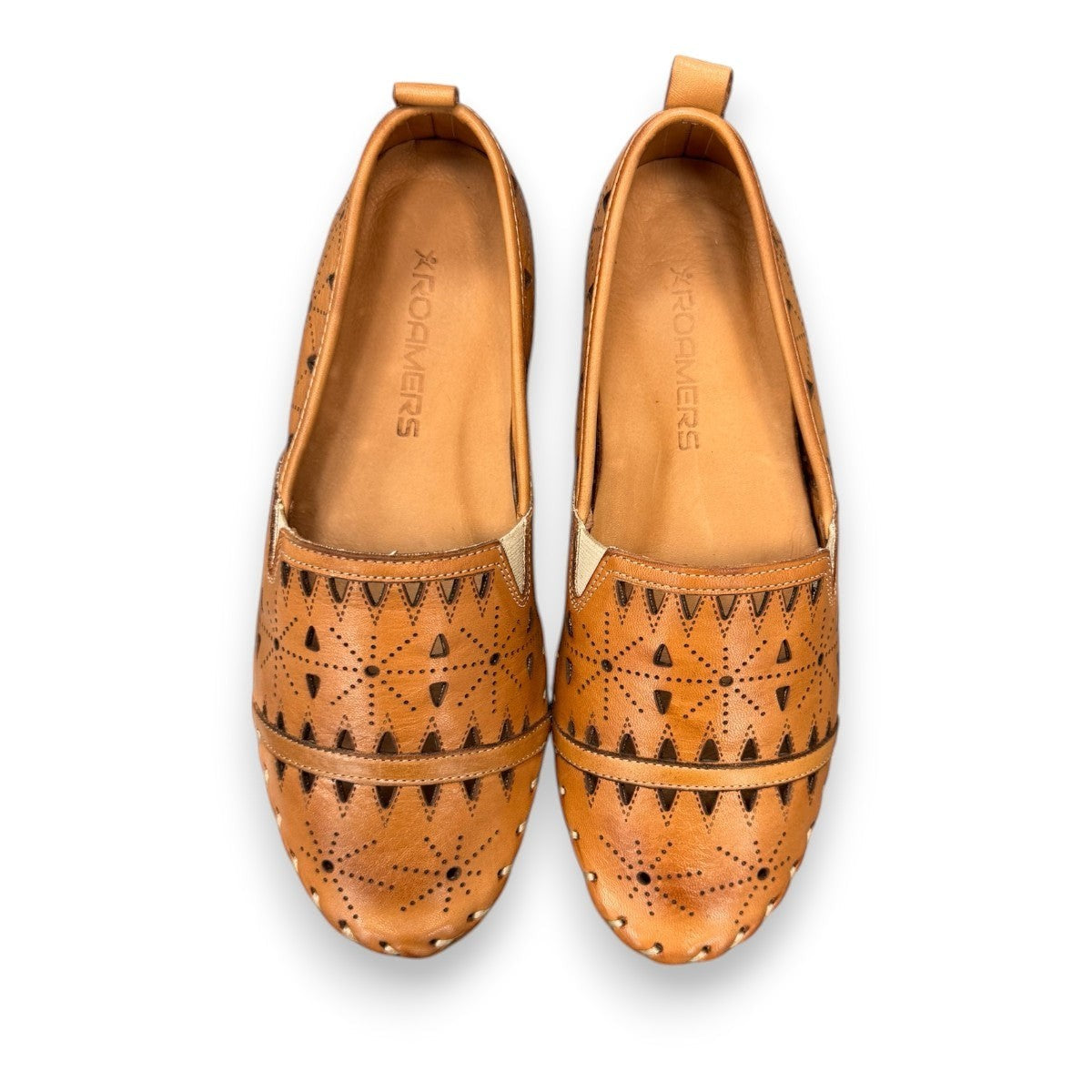 roamers tan leather slip-on loafer with geometric laser cutouts, artisan stitching, and flexible rubber outsole.
photo of the top side