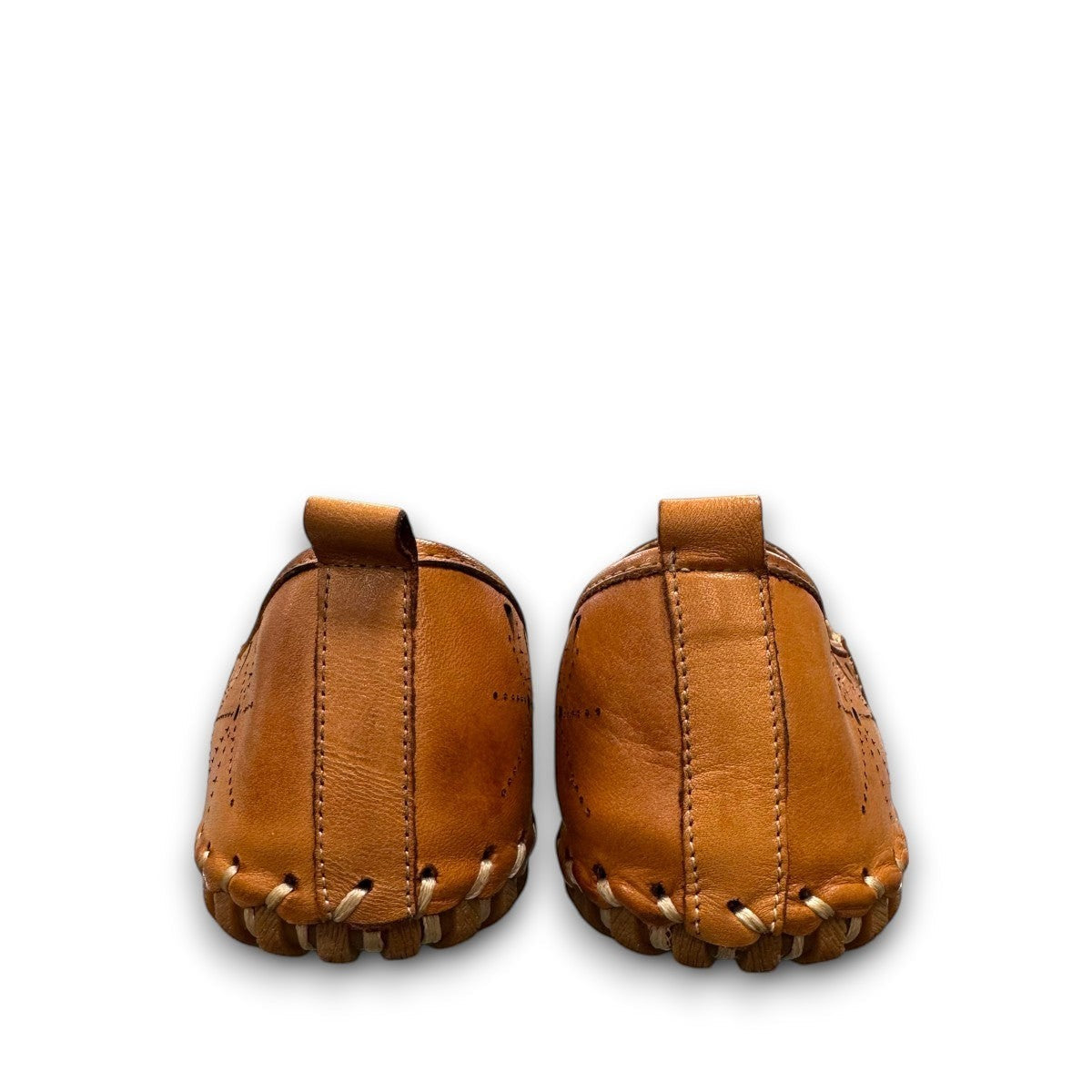 roamers tan leather slip-on loafer with geometric laser cutouts, artisan stitching, and flexible rubber outsole.
photo of the back side