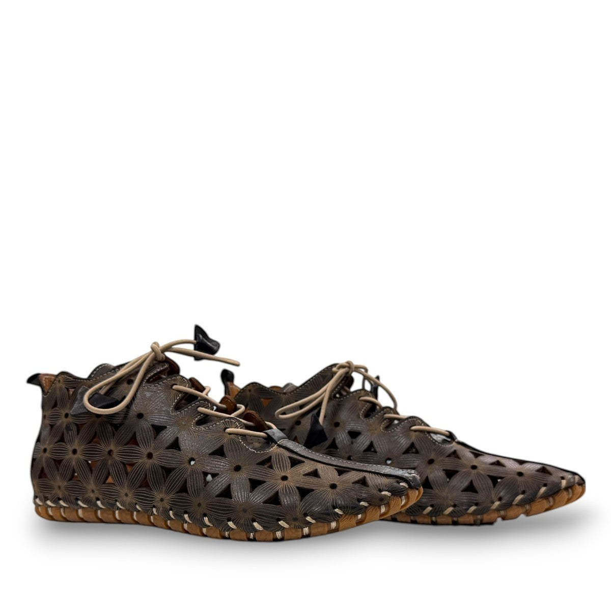 Roamers Venus black leather ankle boots with decorative floral cutouts, elastic lacing, and flat sole.
photo of the side