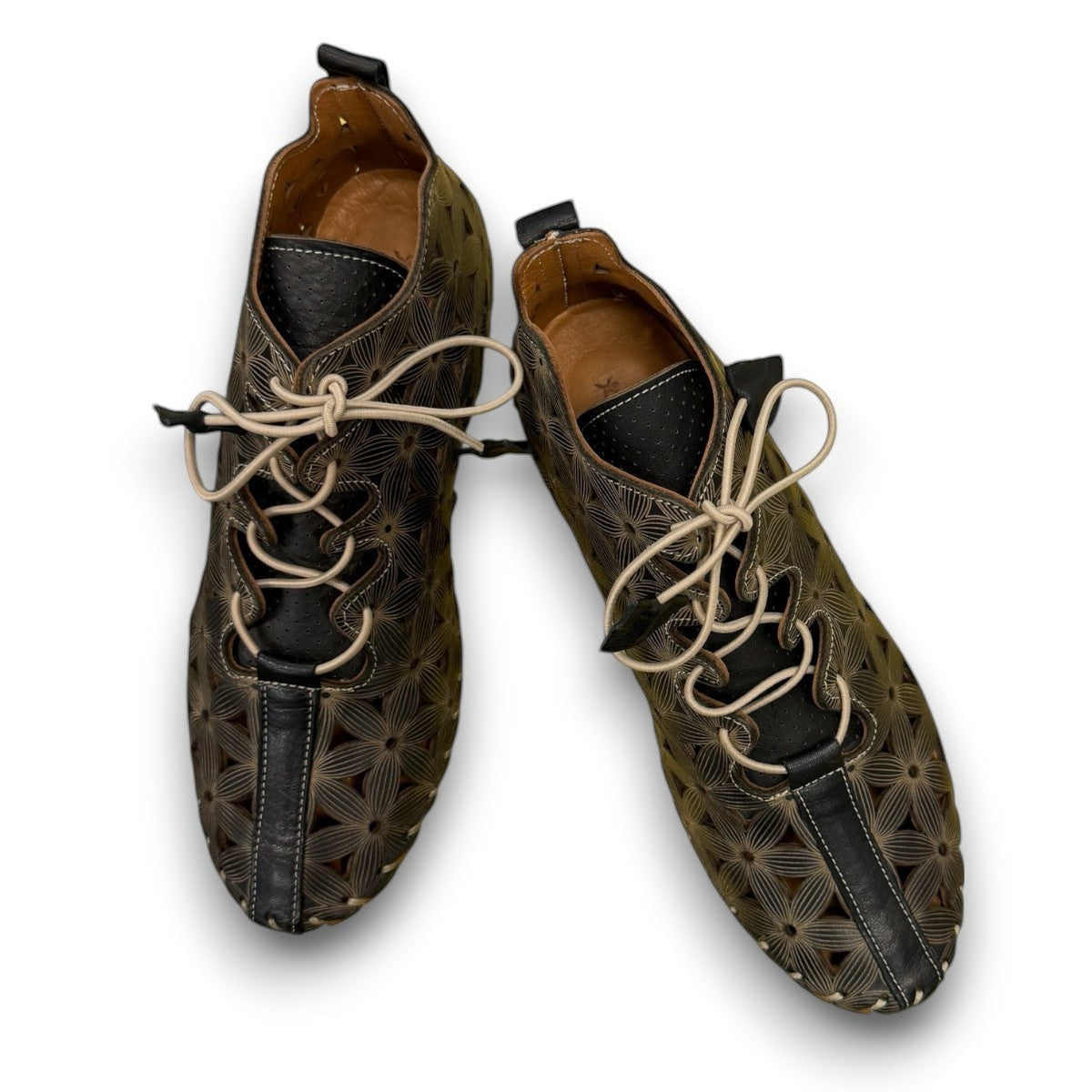 Roamers Venus black leather ankle boots with decorative floral cutouts, elastic lacing, and flat sole.
photo of the top side