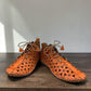 Roamers Venus ankle shoes in sun burn orange leather with decorative floral cutouts and elastic lacing.
photo of the left side