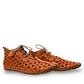 Roamers Venus ankle shoes in sun burn orange leather with decorative floral cutouts and elastic lacing.
photo of the side