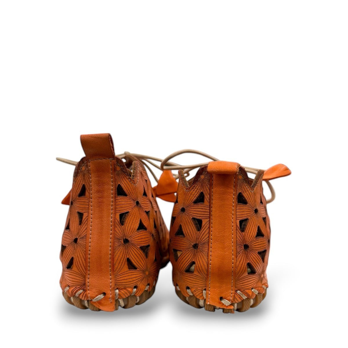 Roamers Venus ankle shoes in sun burn orange leather with decorative floral cutouts and elastic lacing.
photo of the back