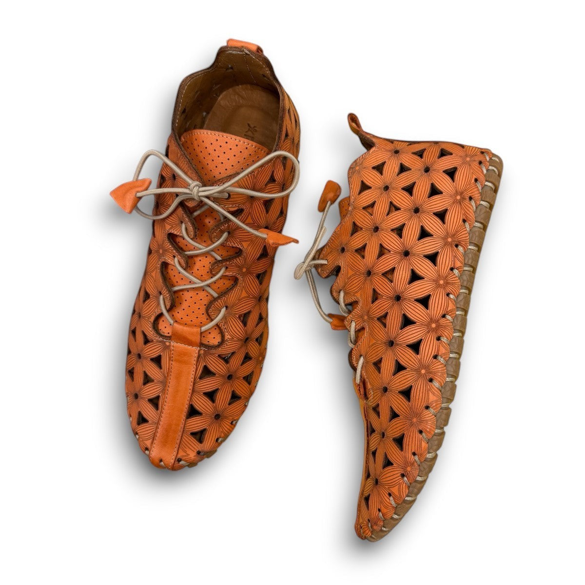 Roamers Venus ankle shoes in sun burn orange leather with decorative floral cutouts and elastic lacing.
photo of the top