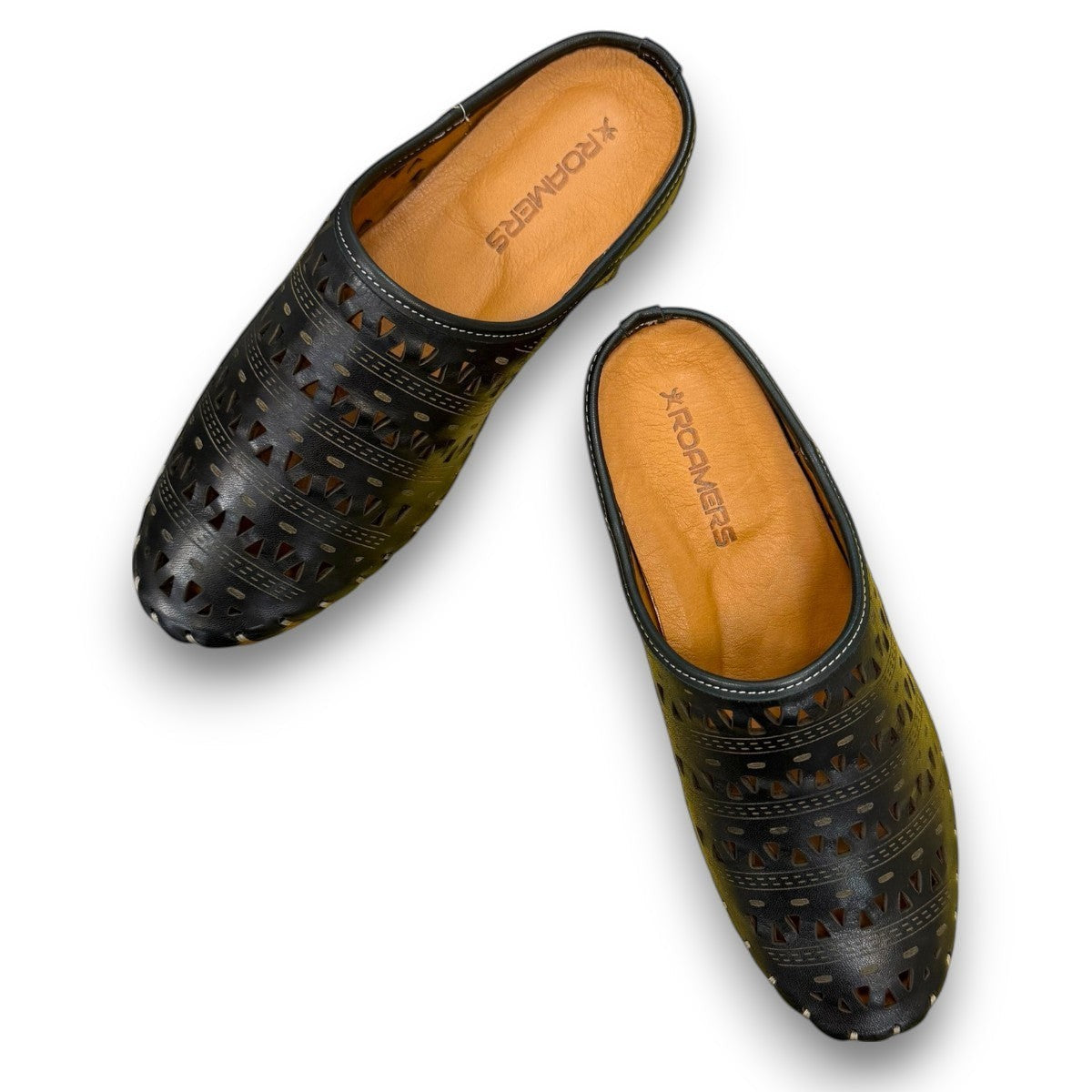 Roamers black leather slip-on mules with perforated cutouts and contrast stitching on a rubber sole.
photo of the top side