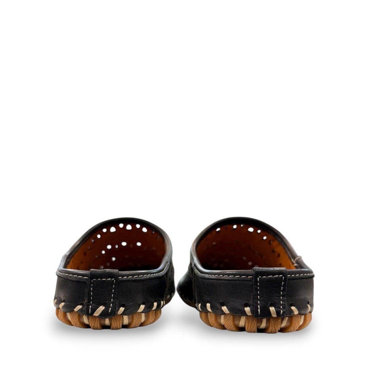 Roamers black leather slip-on mules with perforated cutouts and contrast stitching on a rubber sole.
photo of the back side
