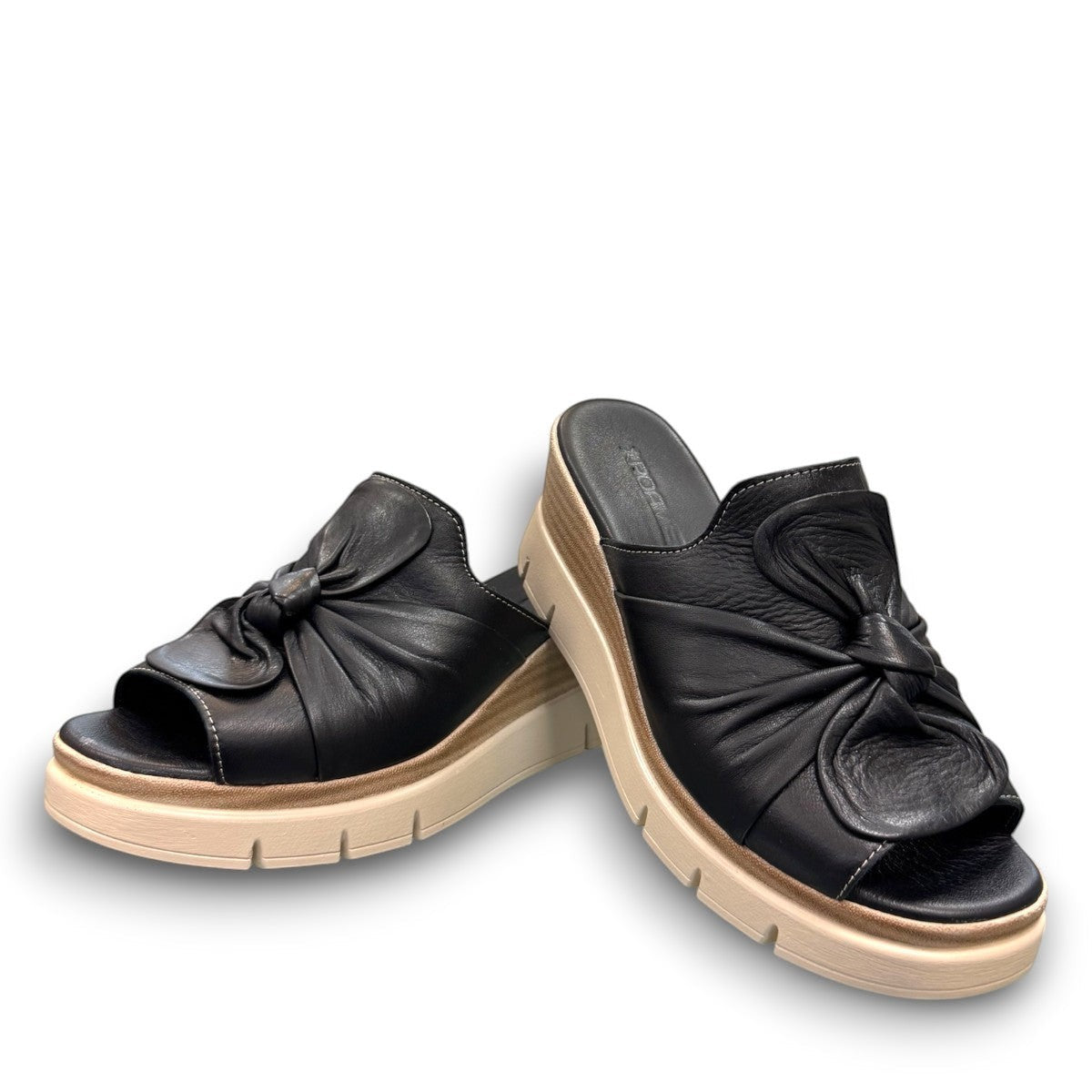 Roamers Veronica black leather slip-on wedge sandal with a knotted detail and platform sole.
photo of the front side