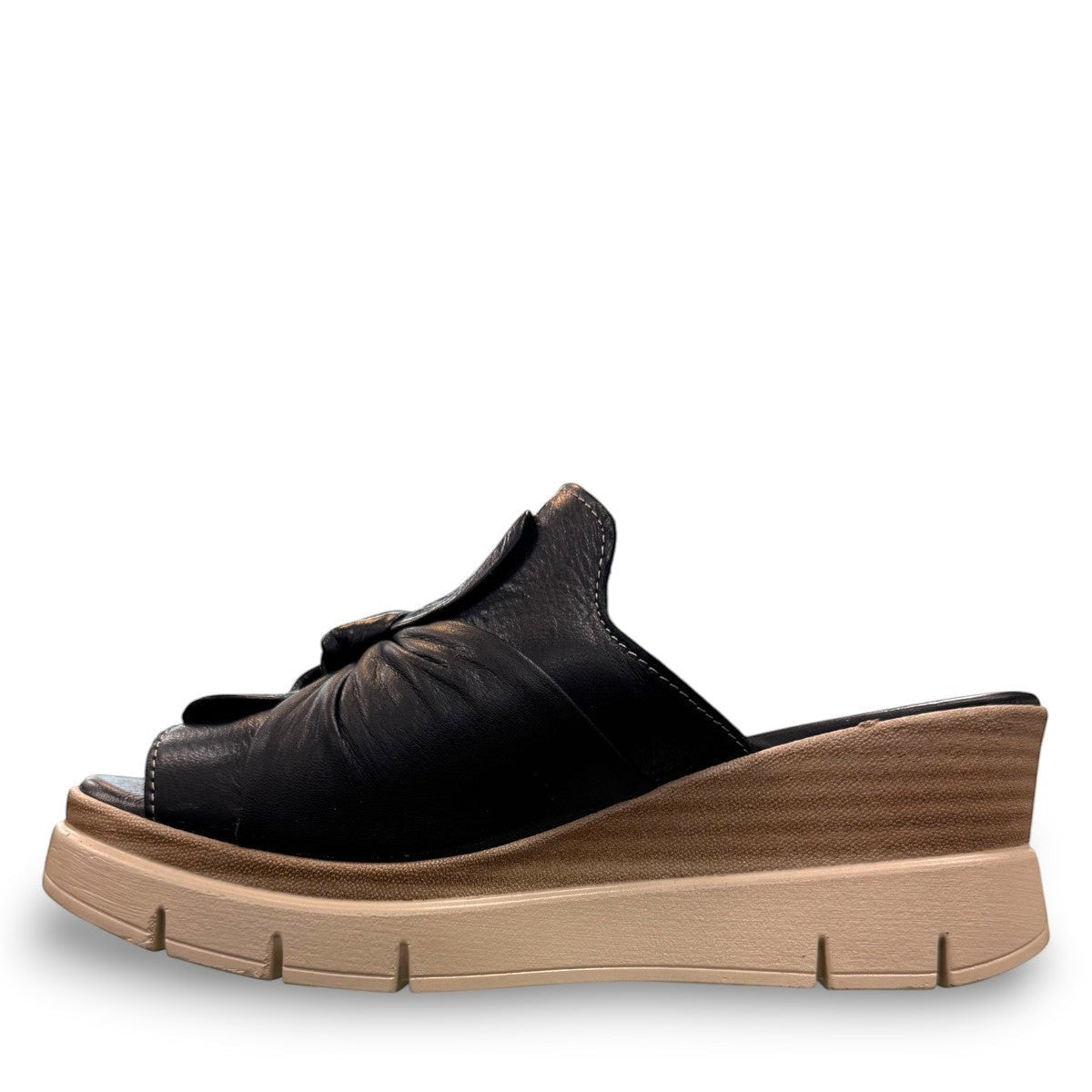 Roamers Veronica black leather slip-on wedge sandal with a knotted detail and platform sole.
photo of the left side