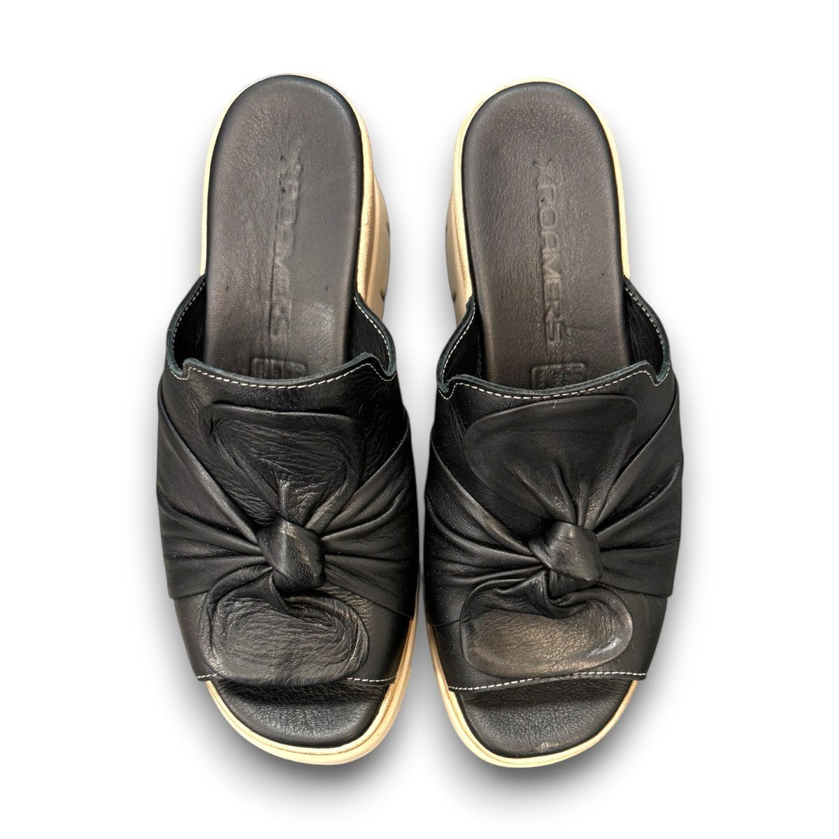 Roamers Veronica black leather slip-on wedge sandal with a knotted detail and platform sole.
photo of the top side