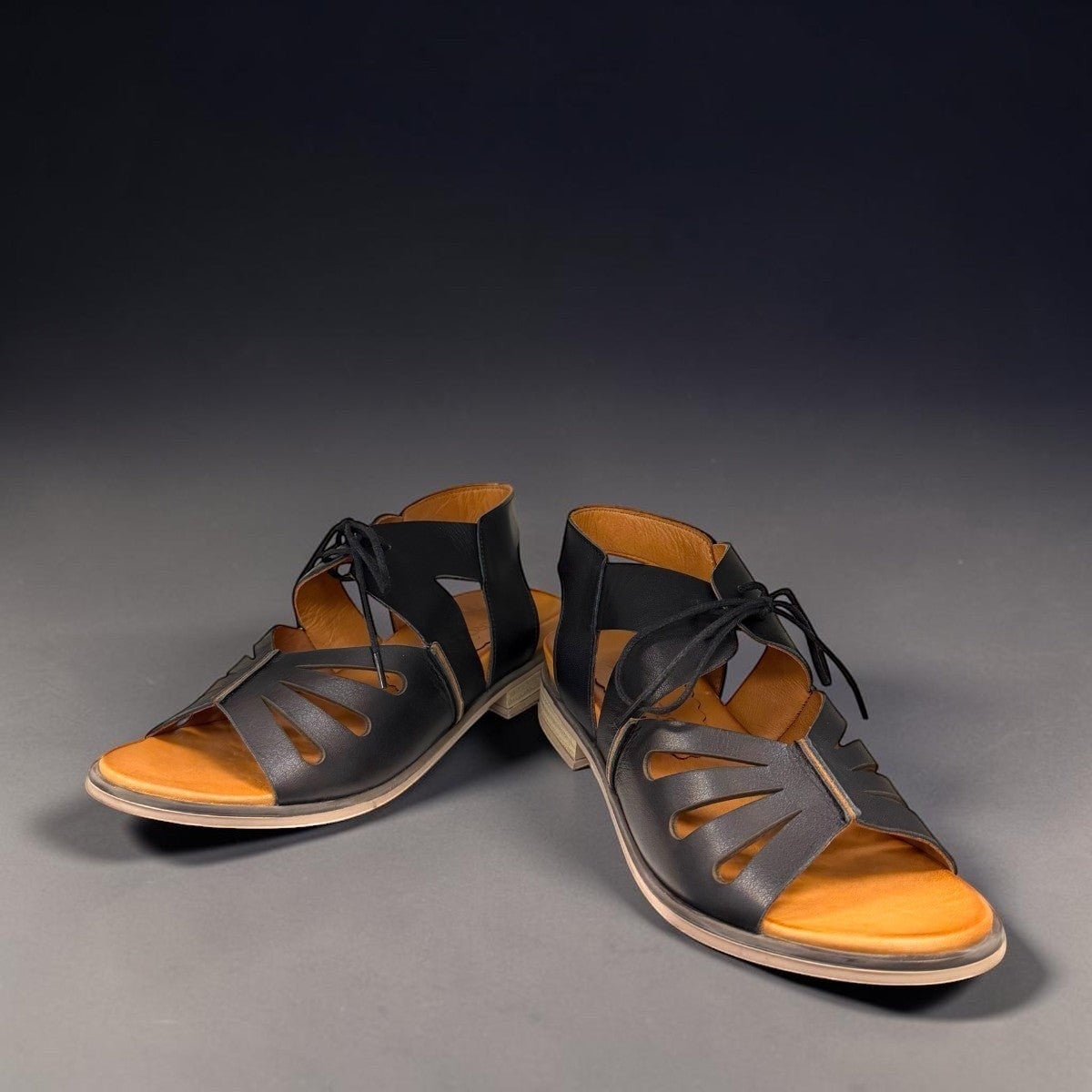 Roamers Vienna black leather lace-up sandals with cut-out design and tan footbed
photo of the front