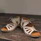 Roamers Vienna silver grey leather sandals with lace-up closure and cut-out floral toe detail.
photo of the front side
