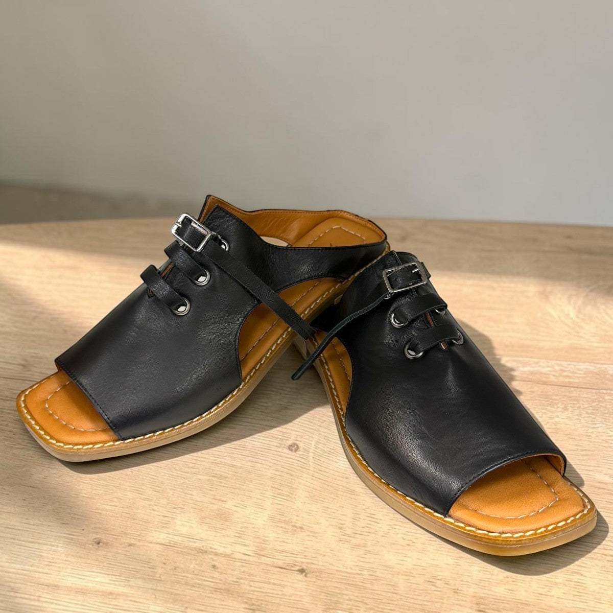 Roamers Whitney black leather backless sandal with lace-up detail and low rubber heel.
photo of the front side