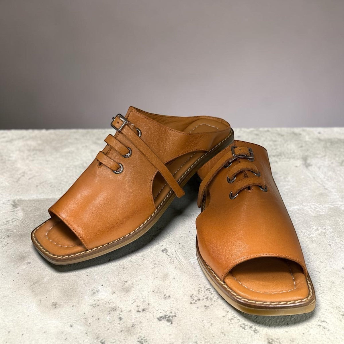 Roamers Whitney backless leather sandals in coconut brown with slip-on design and lace-up detail.
photo of the front side