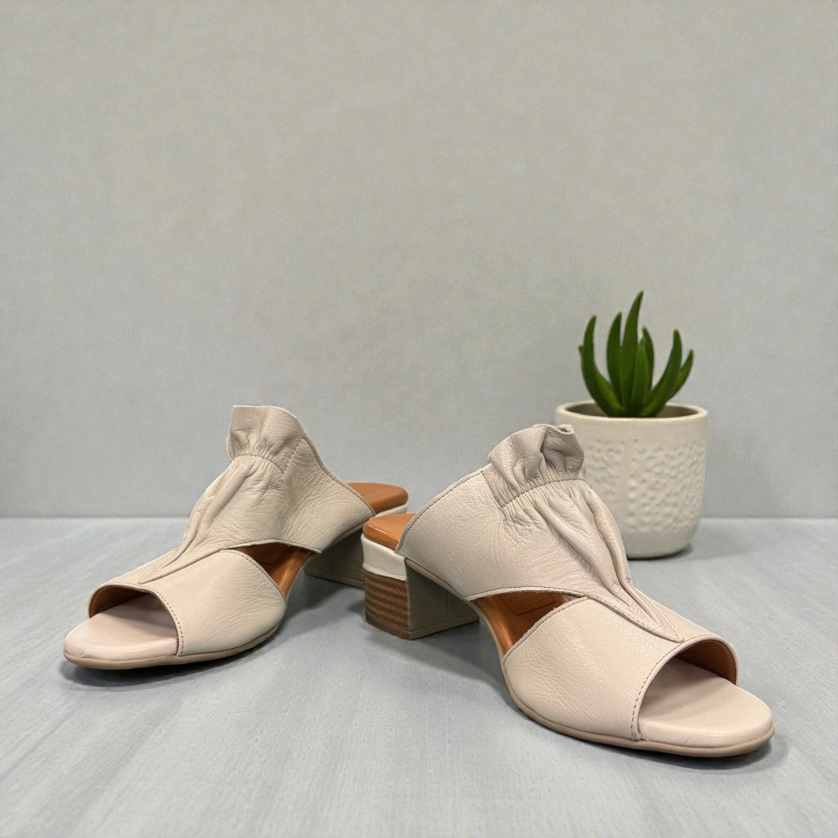 Roamers Zola slides in egret cream leather with a low block heel and gathered front detail.
photo of the front side